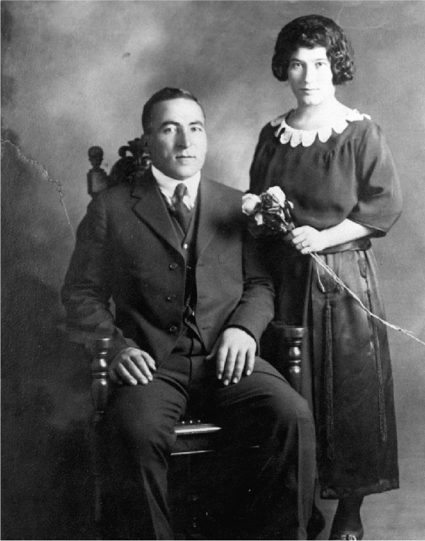 black and white picture of a man and a woman looking at the camera
