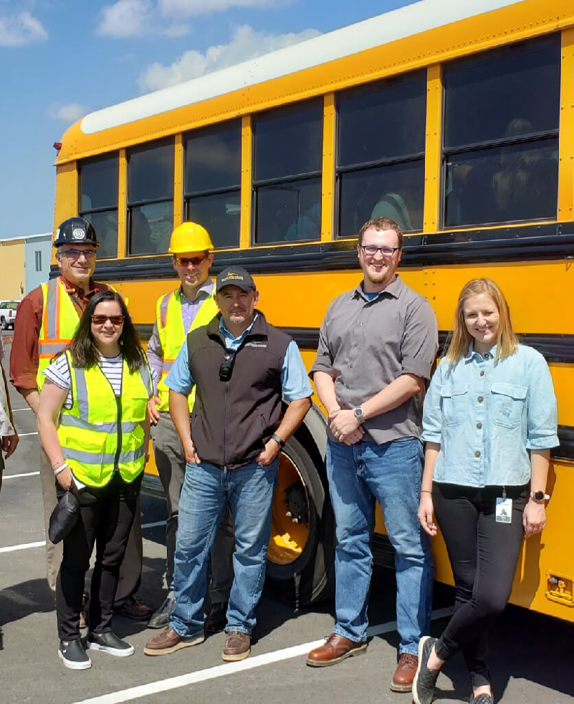 group of people in front of a bus