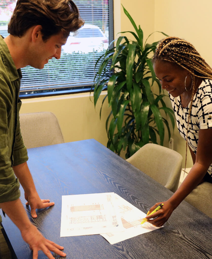 Three people gathered in an office setting